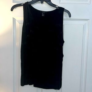 Black top with left pocket. This top has a beautiful animal print.